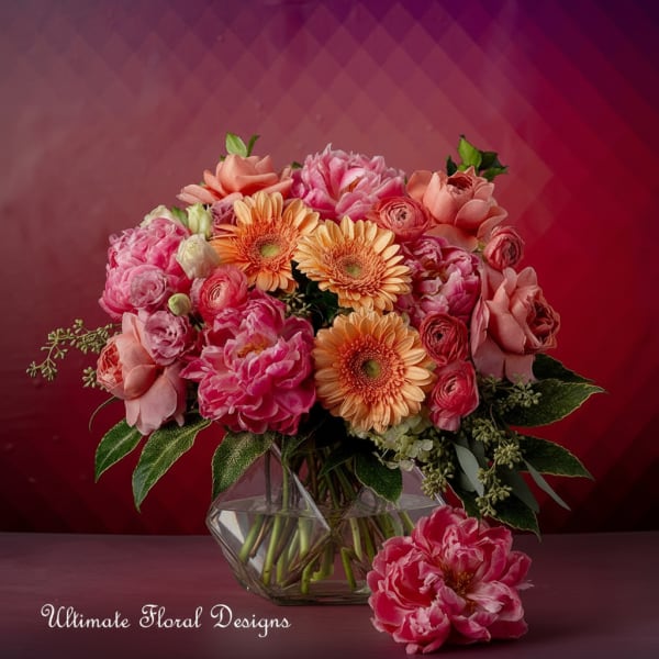 Pink and peach mixed bouquet in a geometric glass vase