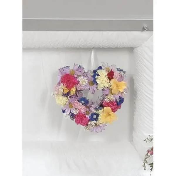 Heart-shaped floral arrangement with mixed colorful flowers