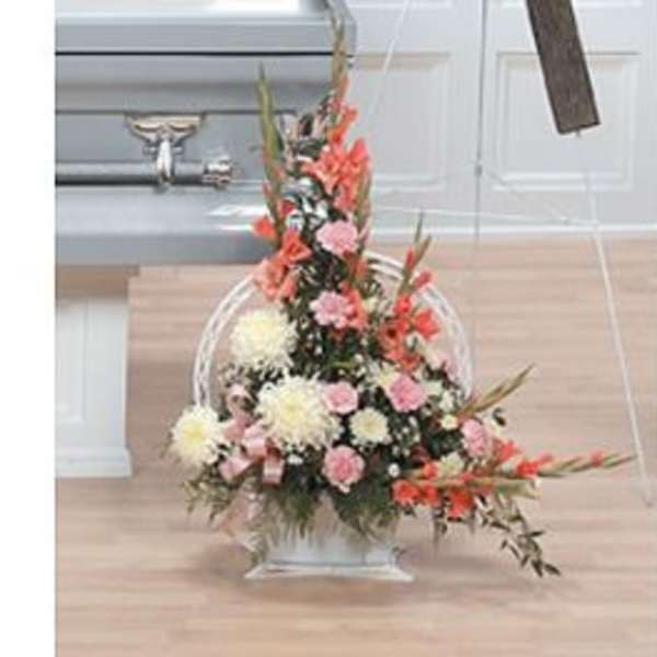 Tall floral arrangement in a clear vase with pink and white blooms