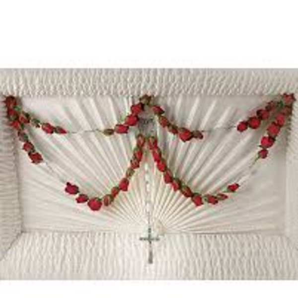 White casket spray with red rose garlands and a cross