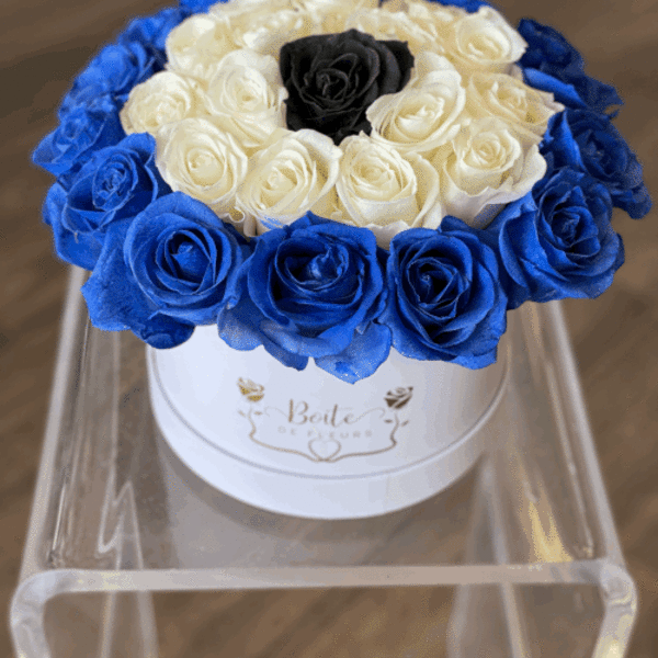 Round box of blue, white, and black roses