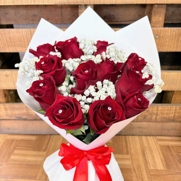 Bouquet of red roses with white baby's breath and a red ribbon