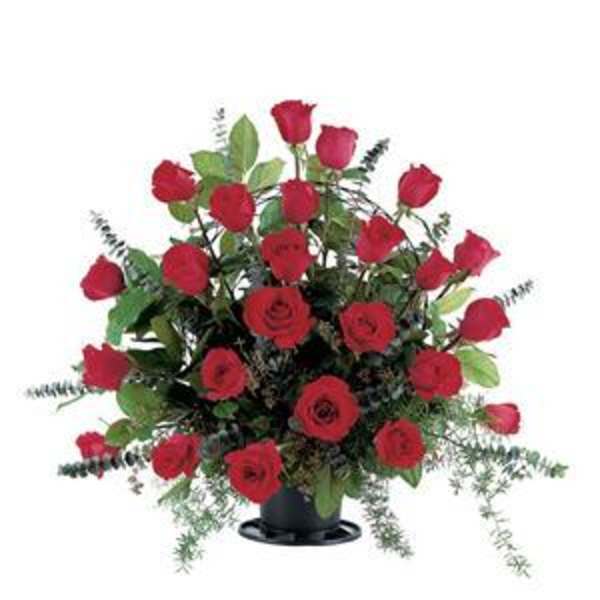 Red roses arranged in a black vase with greenery