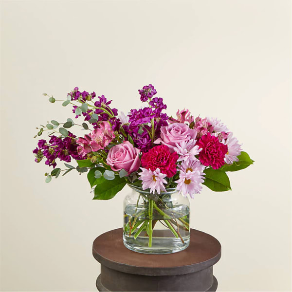Pink and purple mixed bouquet in a clear glass vase