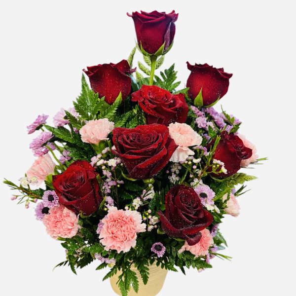Red roses and pink carnations in a gold vase