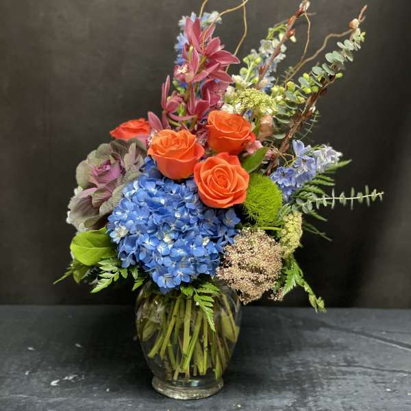 Colorful mixed flower arrangement in a glass vase
