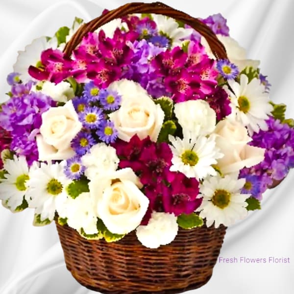 Basket of white roses, daisies, and purple flowers
