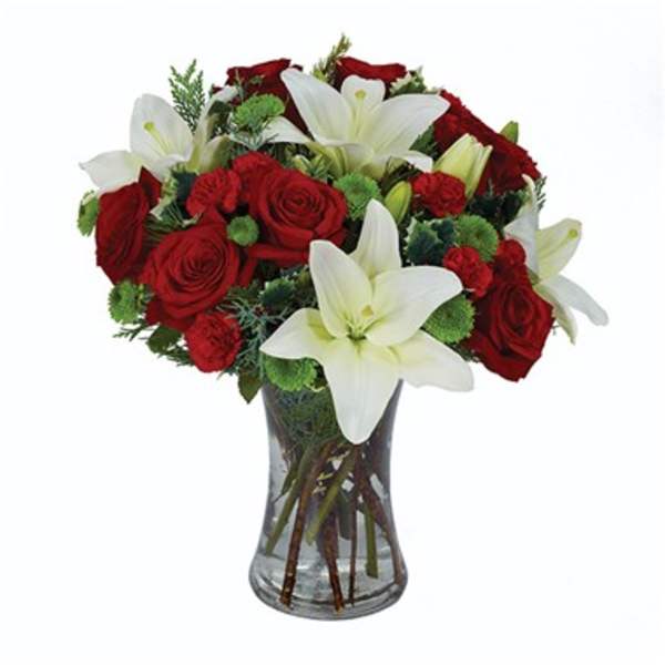 Red roses and white lilies in a clear glass vase
