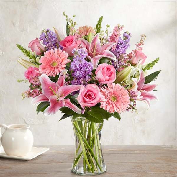 Pink and purple mixed bouquet in a clear glass vase