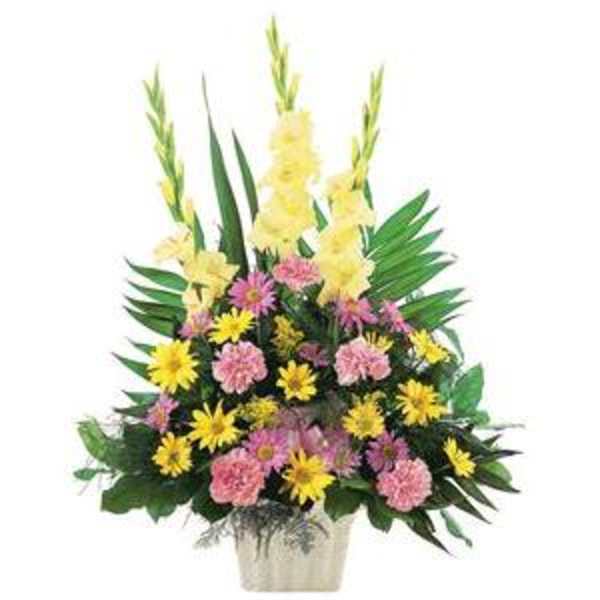 Pink and yellow mixed flower arrangement in a white container
