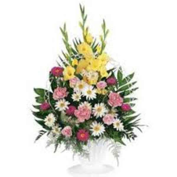 Tall mixed flower arrangement with yellow, pink, and white blooms