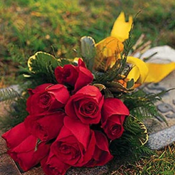 Bouquet of red roses with yellow flowers and greenery