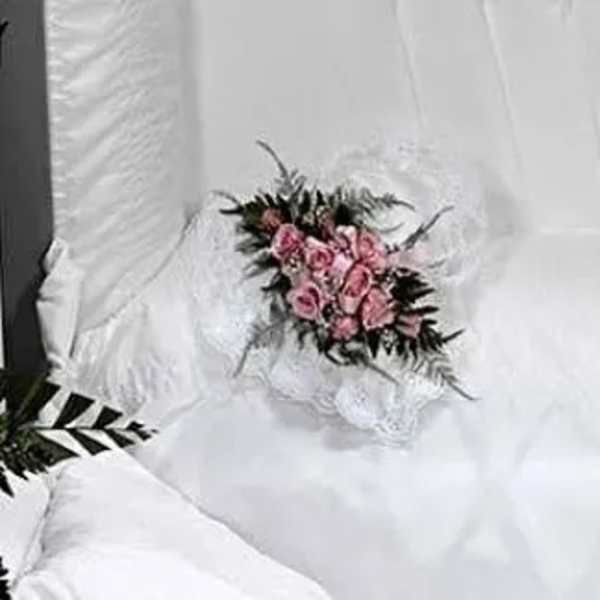 Pink rose bouquet on white fabric