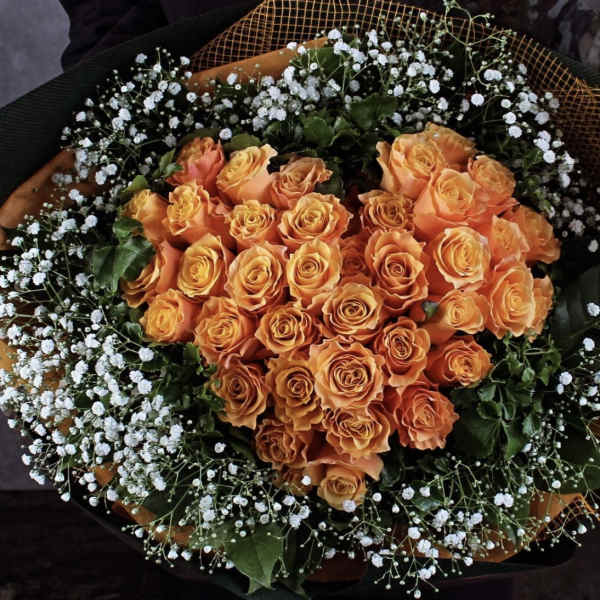 Bouquet of orange roses with white baby's breath
