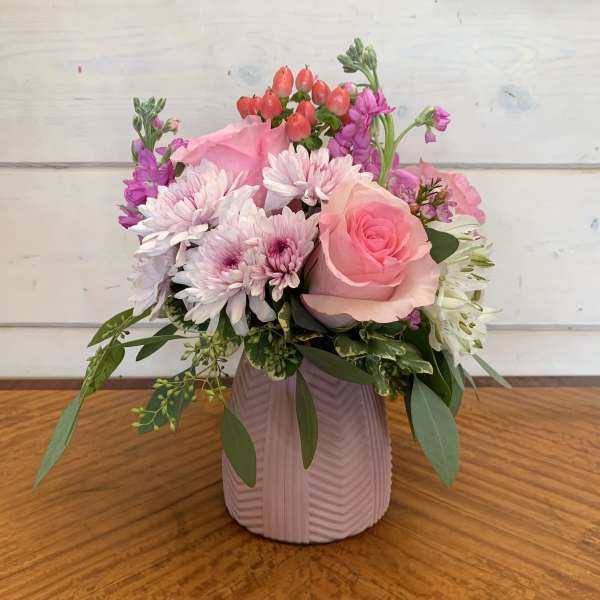 Pink and white mixed bouquet in a ribbed vase