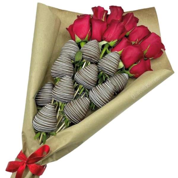 Bouquet of red roses with chocolate-dipped strawberries in brown wrap