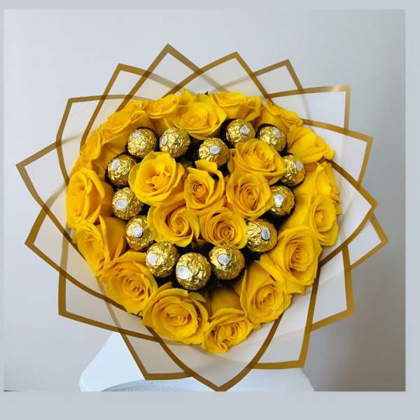 Yellow rose bouquet with gold-wrapped chocolates in a decorative wrap
