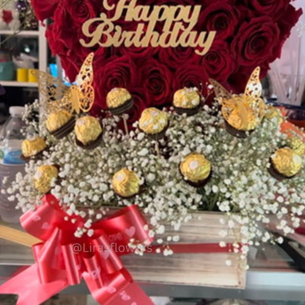 Red rose arrangement with a Happy Birthday topper and gold chocolates