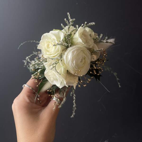 Small bouquet of white roses with delicate filler and grasses