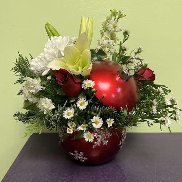 Red ornament vase arrangement with white flowers and greenery