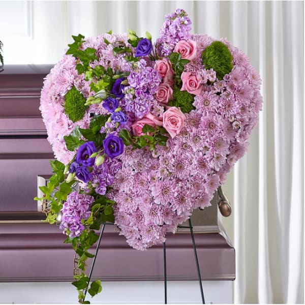 Heart-shaped floral spray with pink and purple flowers on an easel