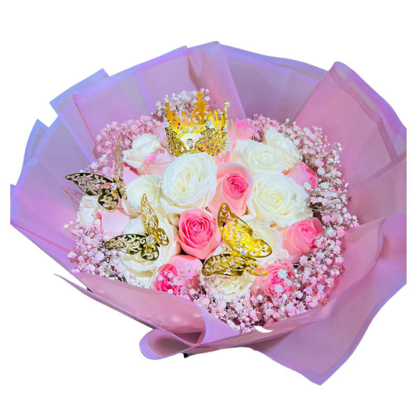 Bouquet of pink and white roses with gold butterflies and a small crown in pink wrapping