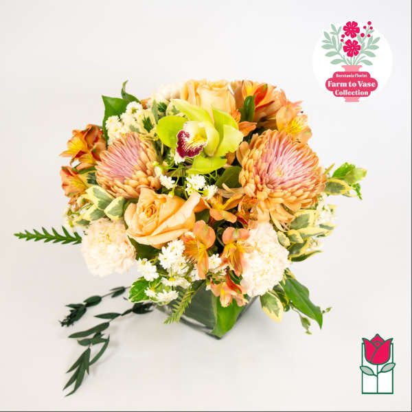 Mixed bouquet of peach and pink flowers in a vase