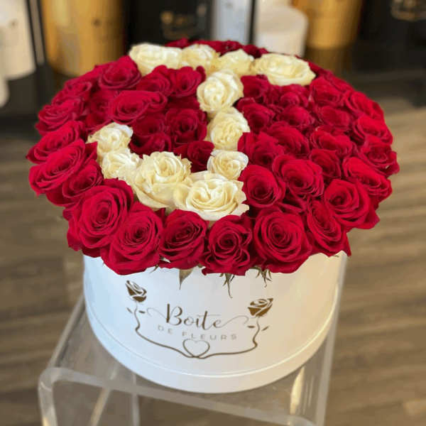 Round box of red and white roses arranged in a heart pattern