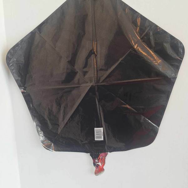 Black star-shaped foil balloon against a white background