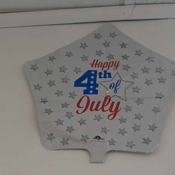 Star-shaped silver foil balloon with 'Happy 4th of July' text and scattered stars.