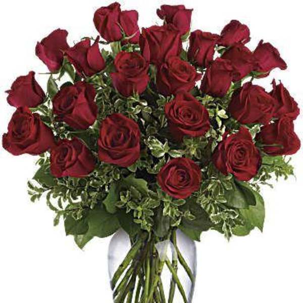 Arrangement of long-stem red roses in a clear glass vase