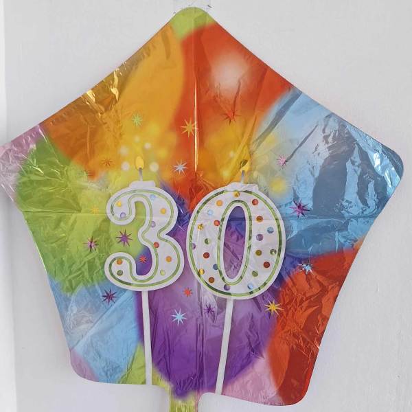 Rainbow star-shaped balloon with a "30" birthday design