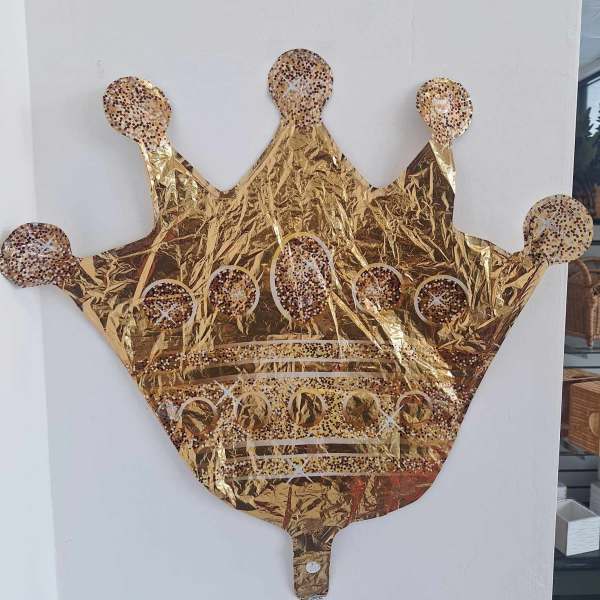 Gold crown-shaped foil balloon with confetti dots