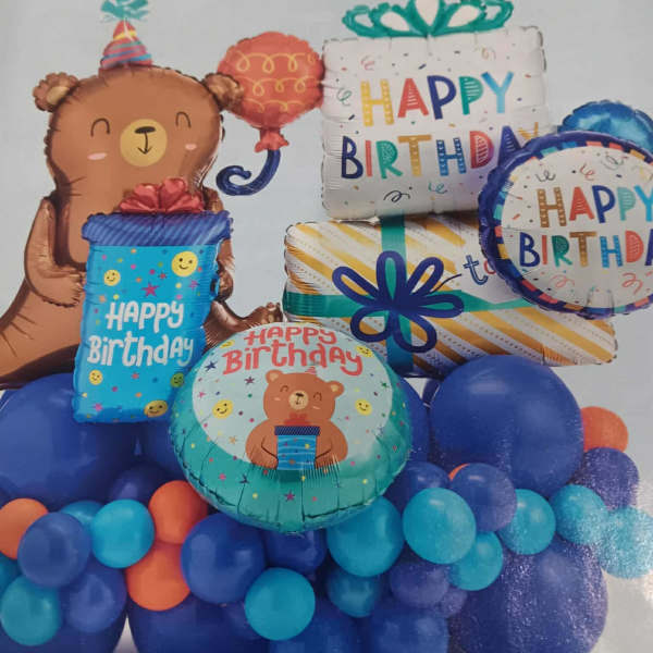 Birthday balloon arrangement with a teddy bear and gift balloons