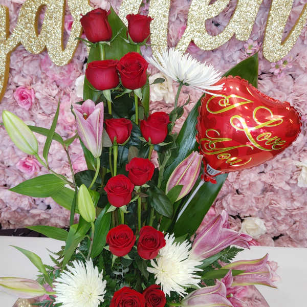 Tall bouquet of red roses, white spider mums, pink lilies, and a heart balloon