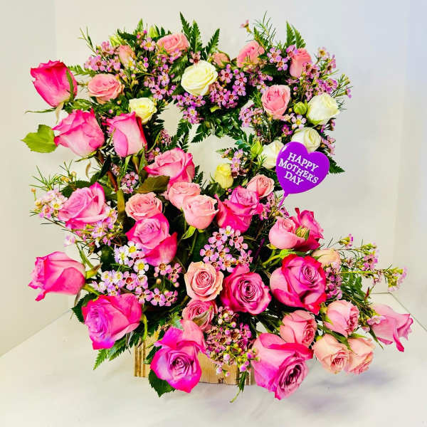 Heart-shaped rose arrangement with a Mother's Day pick