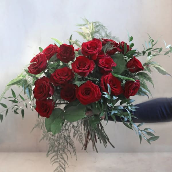 Bouquet of red roses with mixed greenery