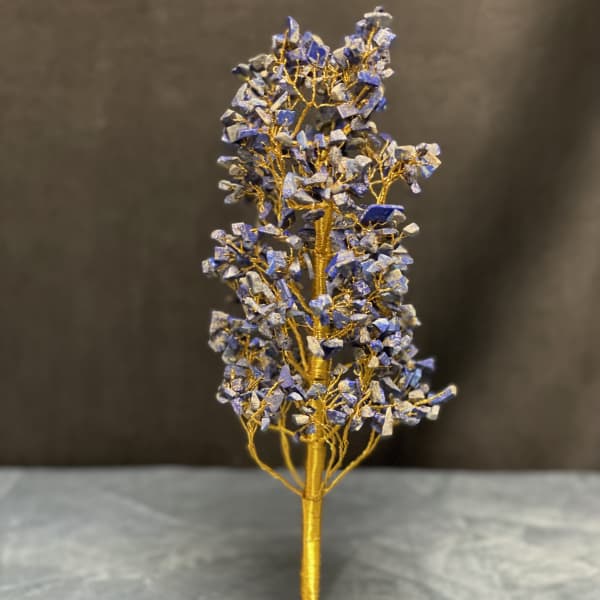 Decorative wire tree with blue stone chips on a matching stone base