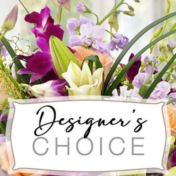 Mixed bouquet of purple, white, and peach flowers with a Designer's Choice sign