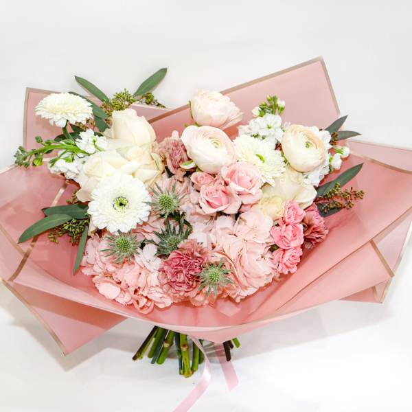 Pink and white mixed bouquet wrapped in translucent pink paper