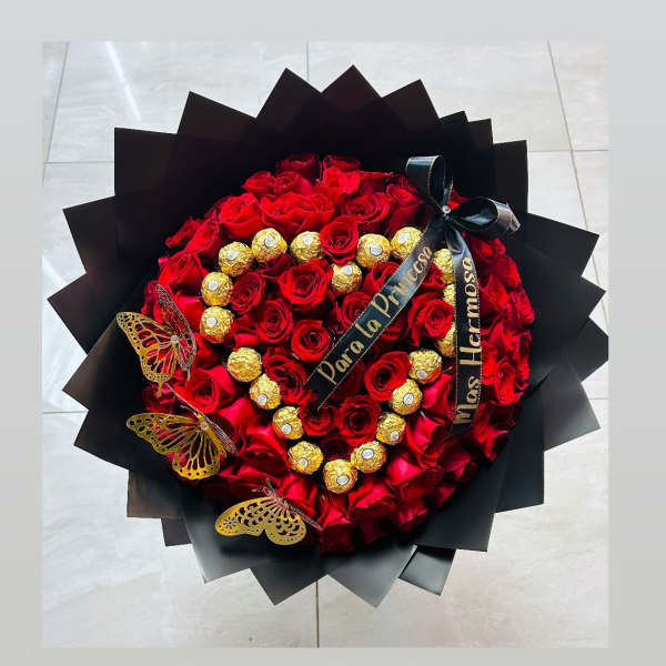 Heart-shaped bouquet of red roses with gold chocolates and black ribbon