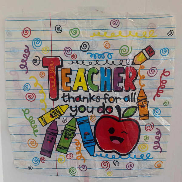 Teacher appreciation poster with crayons and an apple