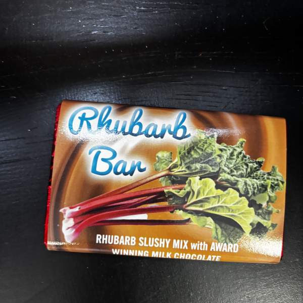 A Rhubarb Bar chocolate package on a dark surface
