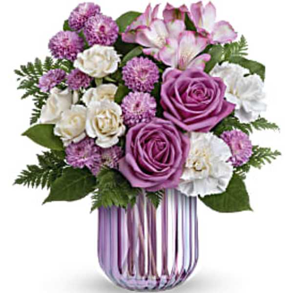 Purple and white flower bouquet in a striped glass vase