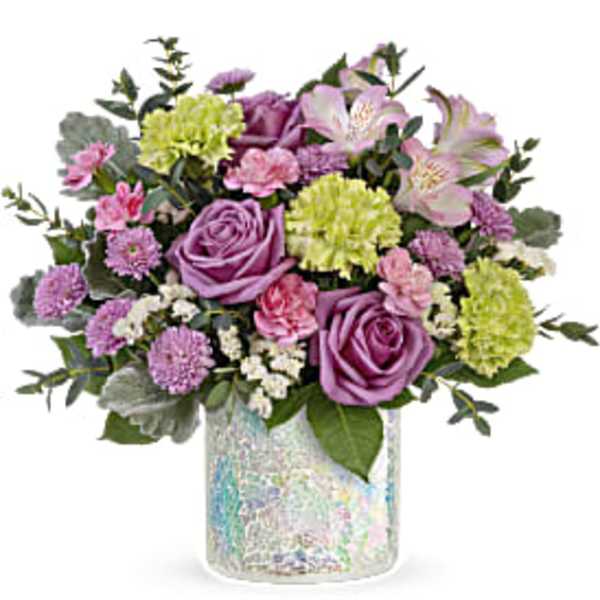 Pink and lavender bouquet in a iridescent glass vase