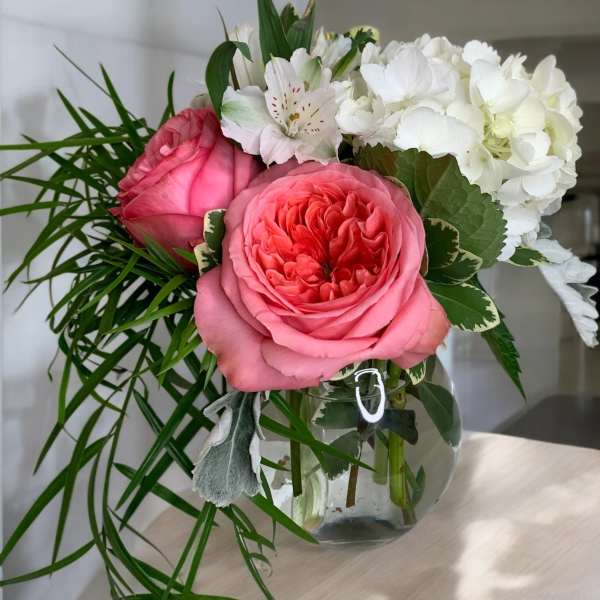 Pink roses and white hydrangeas in a glass vase