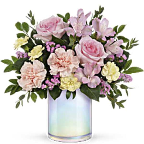 Pink and cream flower arrangement in an iridescent glass vase