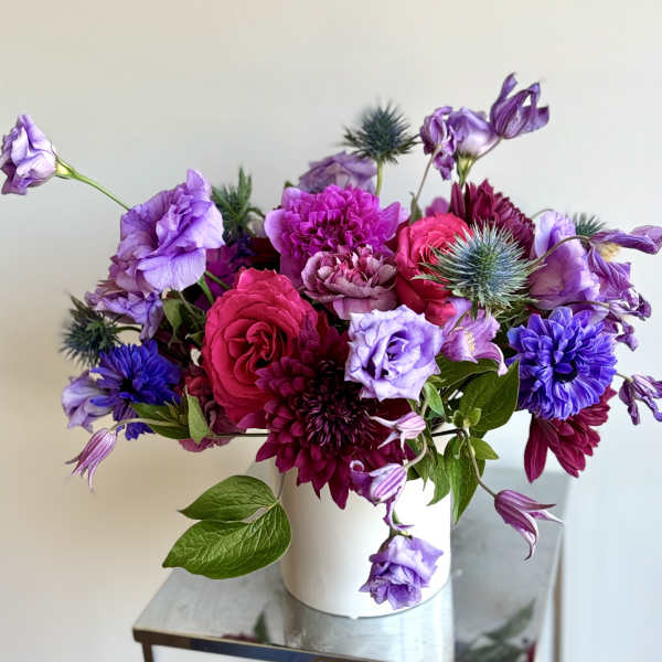 Bouquet of purple and pink flowers in a white vase