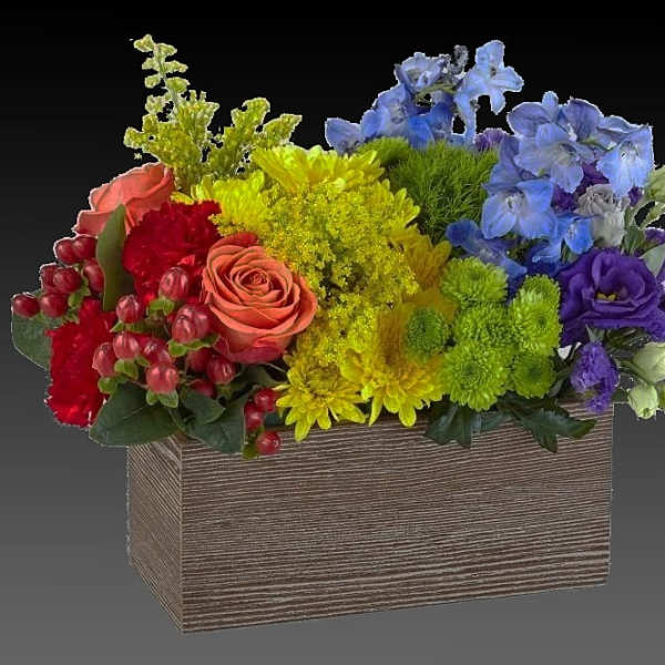 Colorful mixed flower arrangement in a rectangular wooden box