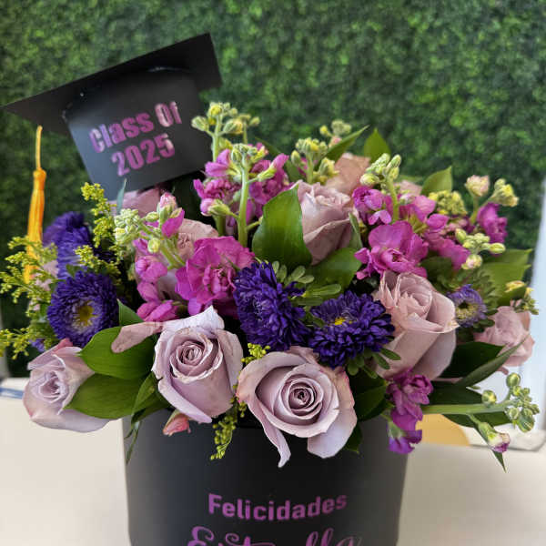Lavender roses and purple flowers in a black graduation box